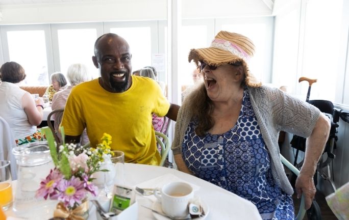 Together Co befriending pair laughing together